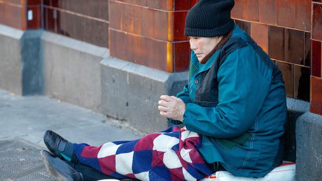 A beggar on the corner of Melbourne CBD’s Flinders and Swanston Streets. Picture: Mark Stewart