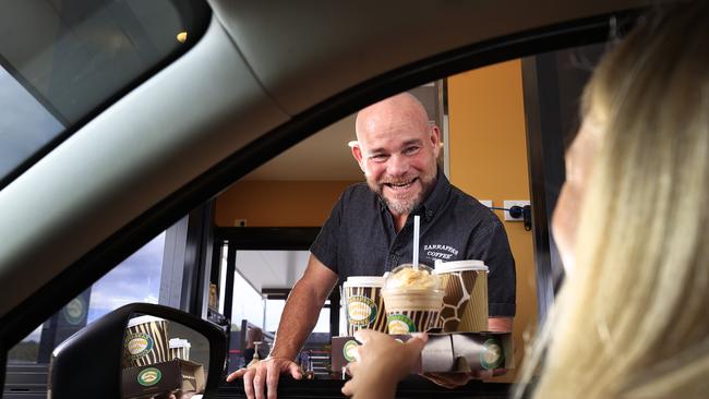 Pics of Zarraffa's boss Kenton Campbell at his new Drive Through Only (DTO) outlet at Beaudesert, serving coffee to a customer. Pics Adam Head