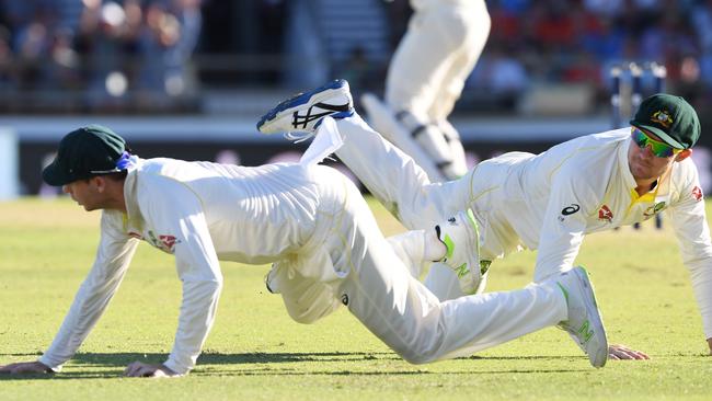 ustralia's Cameron Bancroft and captain Steve Smith miss an opportunity to catch England's Dawid Malan. Photo: AAP