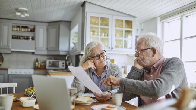 Close up of a senior couple having breakfast and doing bills