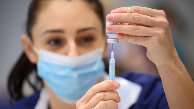 RAMSGATE, UNITED KINGDOM - DECEMBER 16: Medical staff and volunteers prepare shots of the Moderna vaccine at an NHS Covid-19 vaccination centre on December 16, 2021 near Ramsgate, United Kingdom. The Government is pushing the booster jab program as the country recorded its highest number of daily infections since the pandemic began. England's chief medical officer Professor Chris Whitty has warned that more Covid records will be broken as the Omicron variant spreads further. (Photo by Leon Neal - WPA Pool/Getty Images)