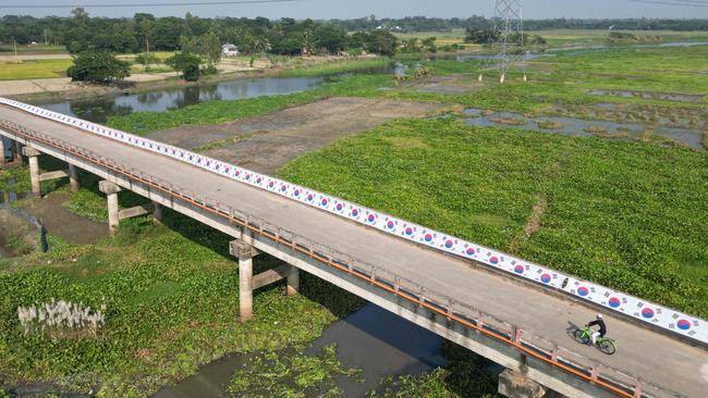 Abu Kowsir’s banner stretches over a local bridge. Picture: Munir Uz Zaman / AFP)