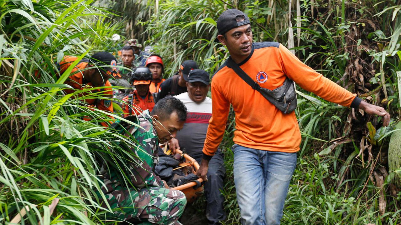 Rescuers carry away a victim after the eruption of Mount Marapi in Agam, West Sumatra. Picture: AFP