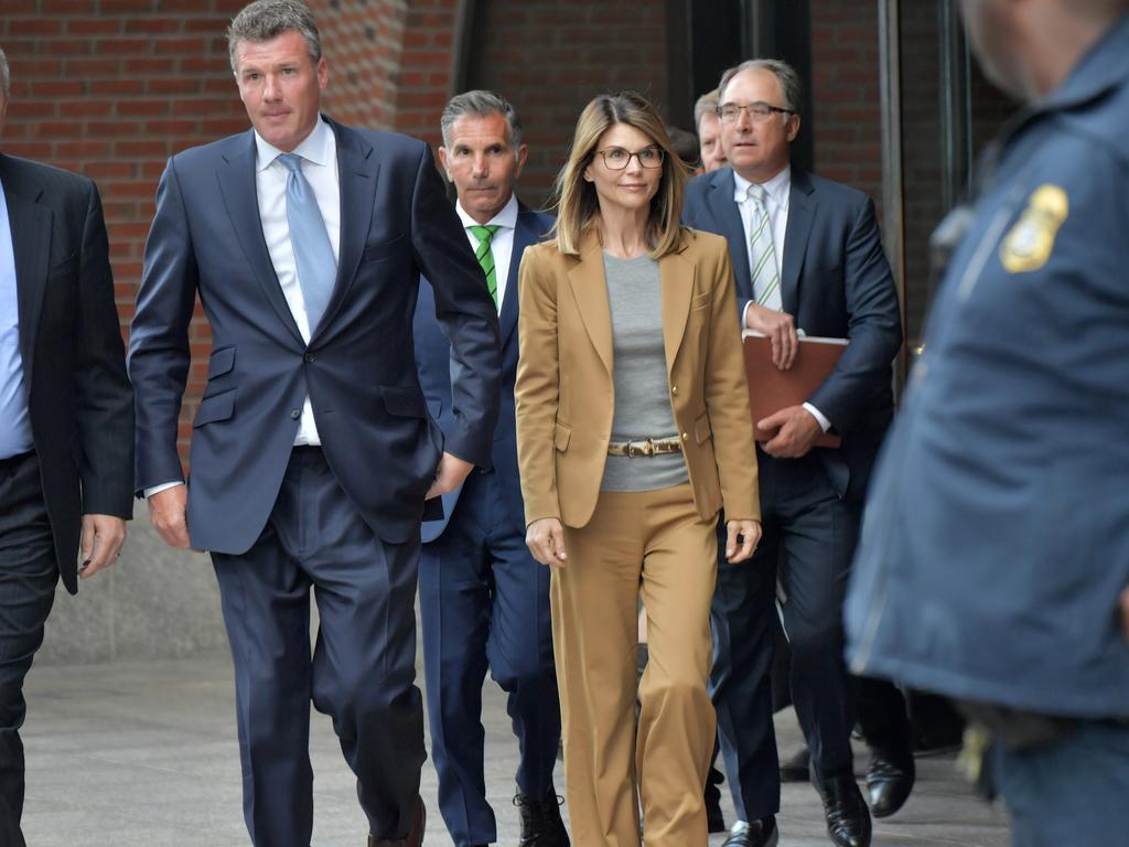  Lori Loughlin and Mossimo Giannulli (wearing the green tie) leave the John Joseph Moakley US Courthouse in Boston. Picture: Getty Images 