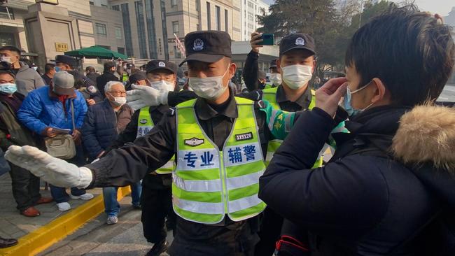 Police push back crowds outside a Shanghai court where Chinese citizen journalist Zhang Zhan was jailed for four years on Monday. Picture: AFP