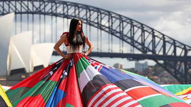 Actor, theatre critic and trans woman, Suzy Wrong in Sydney last month to promote Sydney WorldPride 2023. The dress is made from the national flags of the 71 countries where it is still illegal to be LGBTQ+ on penalty of imprisonment, torture or death. Picture: Tim Hunter.