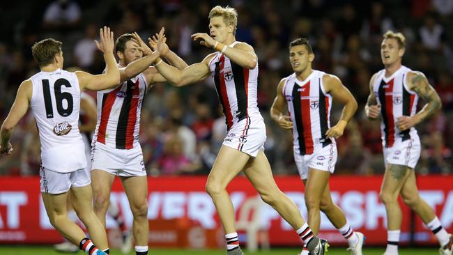 Nick Riewoldt celebrates a goal with teammates.