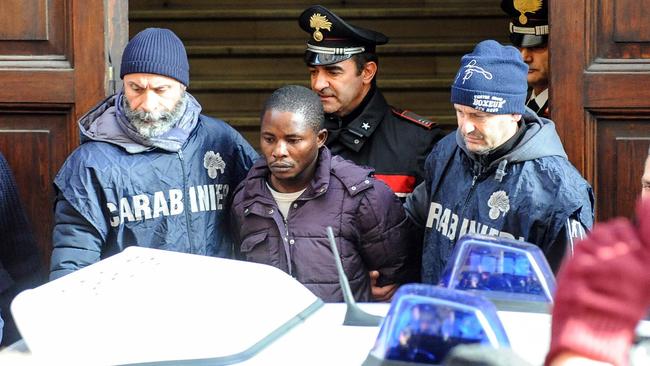 A man identified as Desmond Lucky is escorted by two police officers after being arrested in connection with the probe for the gruesome killing of a young Italian woman, 18-year-old Pamela Mastropietro, whose dismembered remains were found in two suitcases. Picture: Fabio Falcioni/ANSA via AP