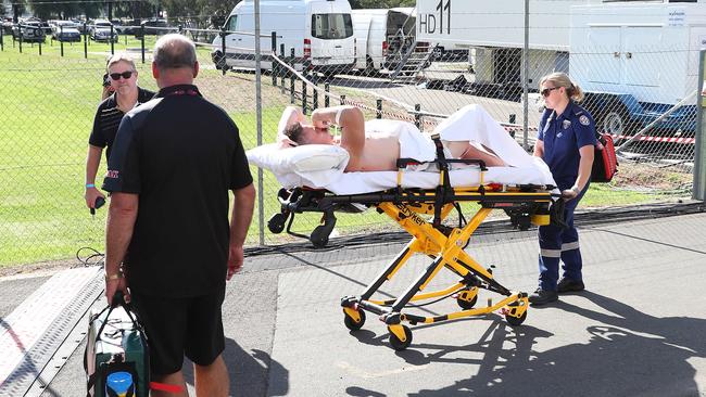 Tim Browne is wheeled to an awaiting ambulance after a shocking injury.