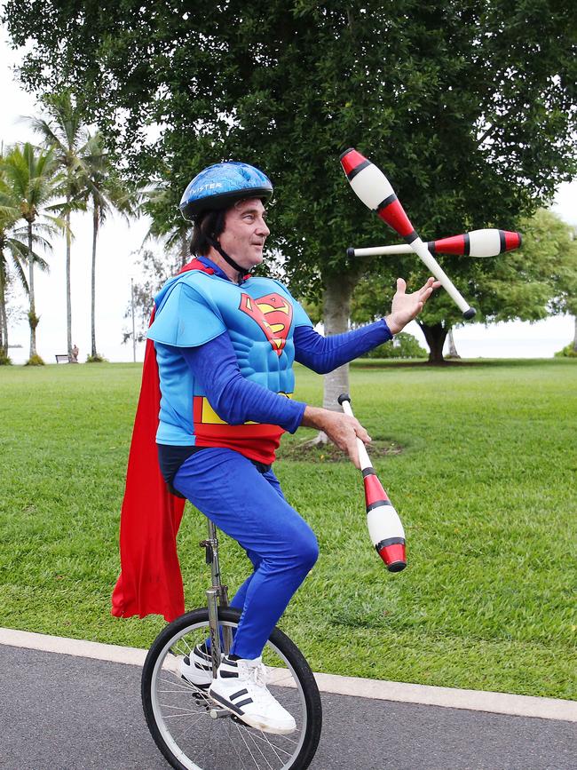 Local identity Flip Ripley participated in the Cairns Regional Council's New Year's Eve superhero fun run by riding a unicycle while juggling dressed as superman on the Cairns Esplanade. Picture: Brendan Radke