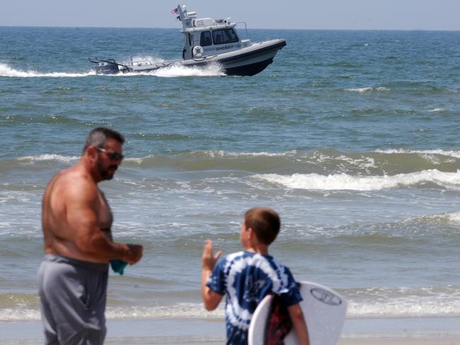 Search mission ... boats and helicopters patrol the coastline near Ocean Crest Pier in Oak Island, North Carolina after the shark attacks. Picture: Mike Spencer/The Star-News via AP