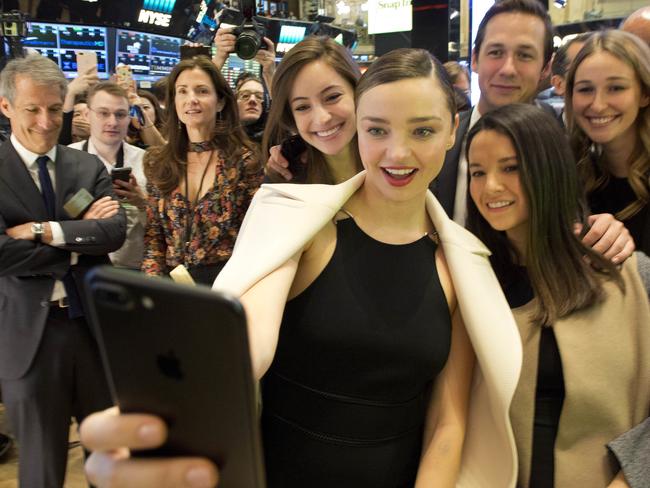 Model Miranda Kerr takes a selfie with friends at the opening bell at the New York Stock Exchange, as Snapchat celebrates its IPO. Picture: AP