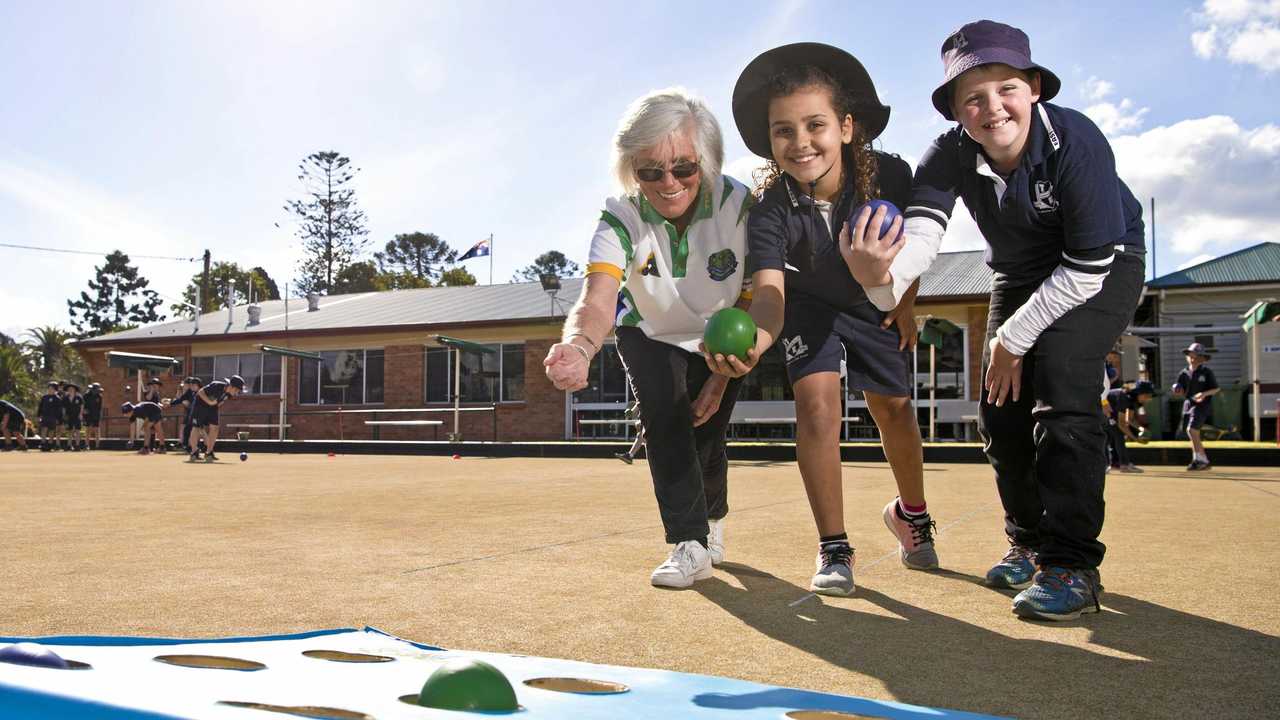 ON TARGET: Toowoomba Bowls Club member Christine Plater (left) teaches Toowoomba East State School students Marianna De Paula and Luke Jordan the finer points of lawn bowls. Picture: Kevin Farmer