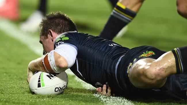 Michael Morgan scores a try to increase the Cowboys’ lead over the Dragons in Townsville. Picture: Getty Images