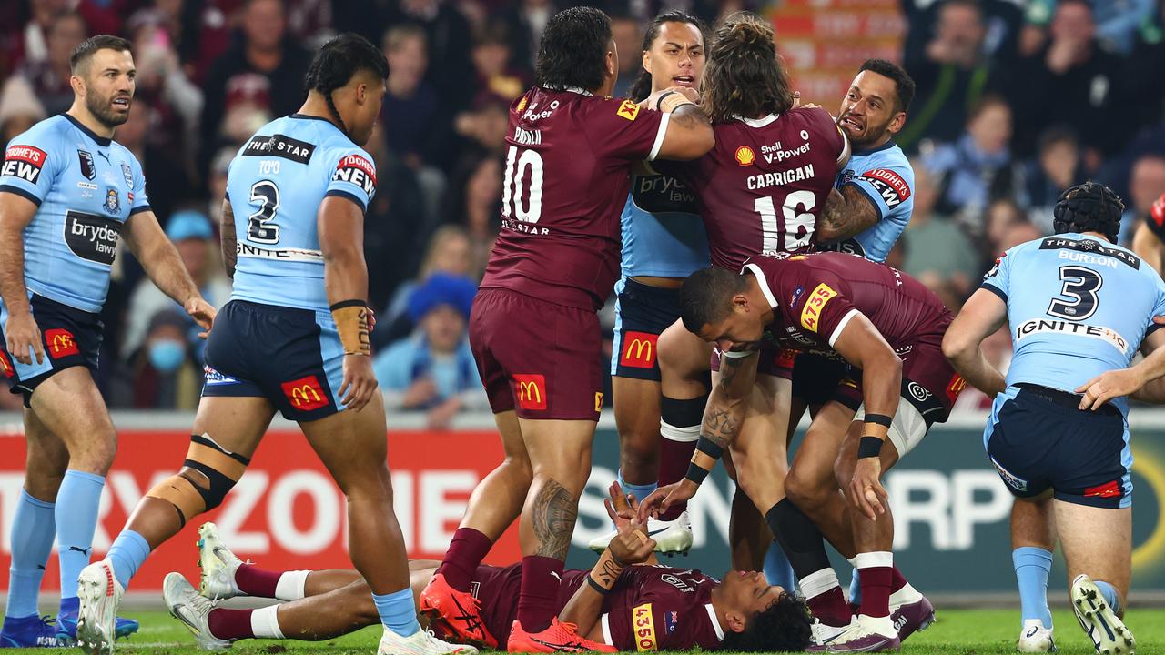 Maroons winger Selwyn Cobbo is attended to by Dane Gagai, while Blues five-eighth Jarome Luai is held by Josh Papalii and Pat Carrigan. Picture: Chris Hyde/Getty Images