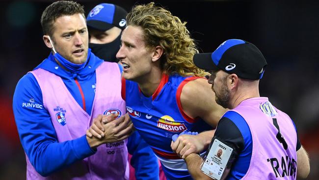 Aaron Naughton is helped from the field by trainers after suffering a head knock. Picture: Quinn Rooney/Getty Images