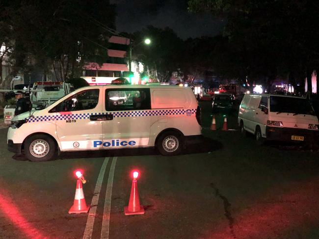 Police blocked off Old Pittwater Rd to traffic and pedestrians near the site of a factory fire. Picture: Jim O'Rourke