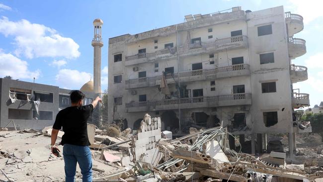 A man stands near the rubble of a building levelled by an Israeli airstrike that targeted the southern Lebanese village of Abbassiyeh on October 18. Picture: Bilal Kashmar / AFP