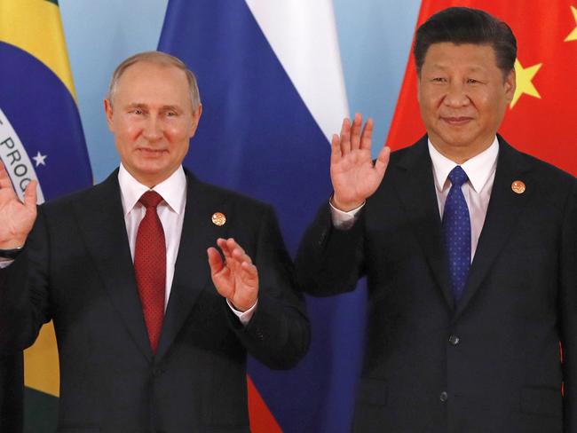 North Korea does have friends including Chinese President Xi Jinping, right, and Russian President Vladimir Putin. Picture: Tyrone Siu/AP