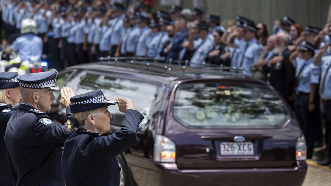 Commissioner Katarina Carroll salutes the coffins of Constable Rachel McCrow and Constable Matthew Arnold. Picture: QPS / via NCA Newswire