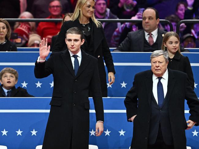 Barron Trump, with his grandfather Viktor Knavs, had a breakout public moment at inaugural celebrations. Picture: AFP