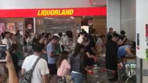 Shoppers crawl under doors as Gold Coast supermarket opens.