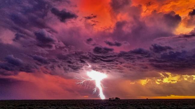 Lightning during sunset, Carriewerloo Station, South Australia. Picture: Amanda Michael