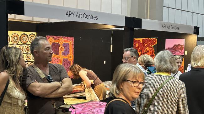 Before: the APYACC stall in the corner of the Darwin Convention Centre bears an APY Art Centres sign.