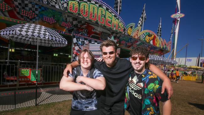 Cayden Dienelt, 17, Richard Smith, 19, and Fletcher Smith, 17, enjoying the third and final day of the Royal Darwin Show. Picture: Glenn Campbell