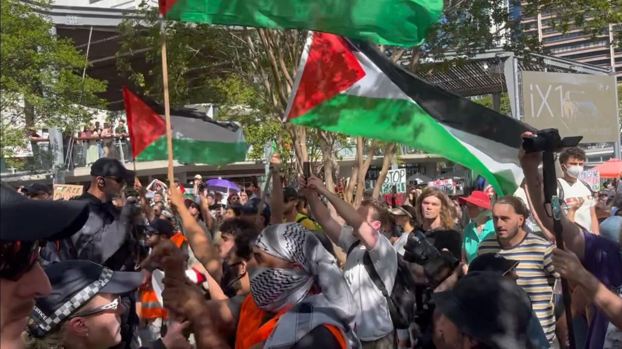 Palestine supporters at the rally Sunday afternoon as a church group performs the haka. Picture: Liam Kidston