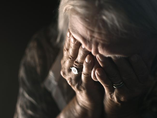 ISTOCK GENERIC -  Desperate senior crying in a dark room. Perfectly usable for a wide range of topics like depression, loneliness or mental health in general.