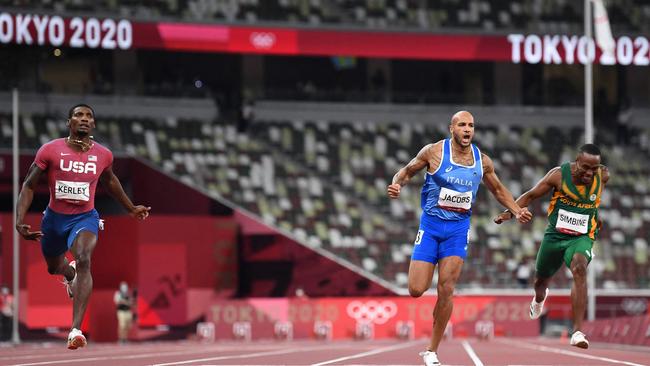 Lamont Marcell Jacobs, centre, crosses the line ahead of USA's Fred Kerley, left, and South Africa's Akani Simbine, right. Picture: Jewel Samad/AFP