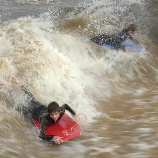 Children taking advantage of the standing waves at the Dee Why Lagoon entrance in 2007. Picture: Martin Lange