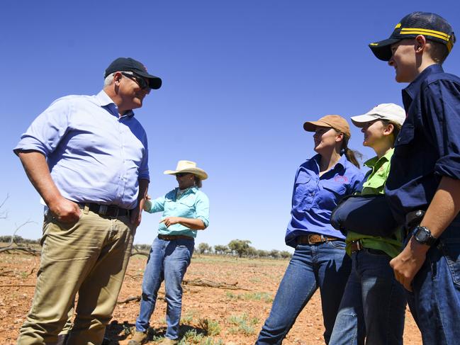 Prime Minister Scott Morrison is reunited with the Tully siblings at their family property Bunginderry Station outside Quilpie yesterday. Picture: Lukas Coch/AAP/NCA NewsWire