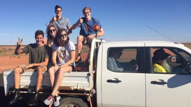 Australian swimmers Mitch Larkin (back left), Mack Horton (back right), Emily Seebohm (middle), Cameron McEvoy (front left) and Cate Campbell (front right) ride in the back of a ute in Central Australia last week. Source: Instagram