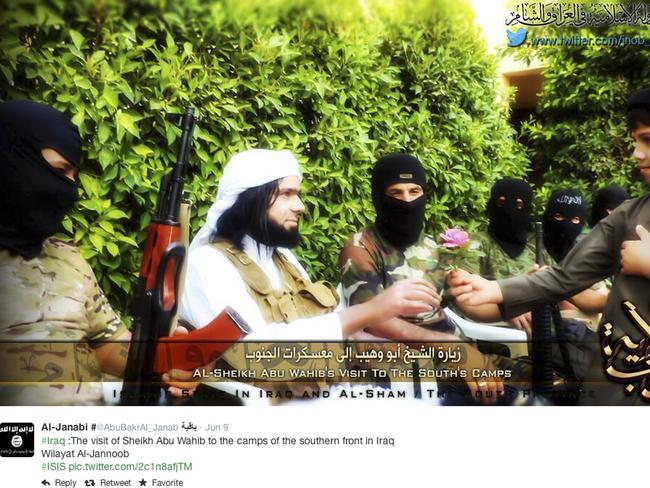 Propaganda ... a screen grab from an Islamic State group affiliated Twitter account purports to show senior military commander Abu Wahib handing a flower to a child while visiting southern Iraq, as part of the group's broad social media campaign. Picture: AP