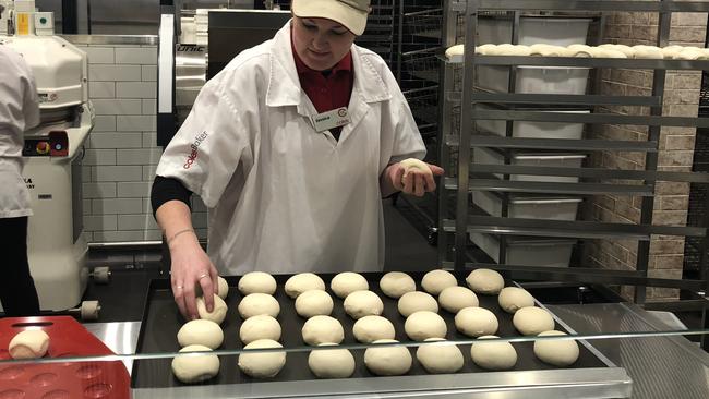 Fresh bread rolls being baked in preparation for opening.