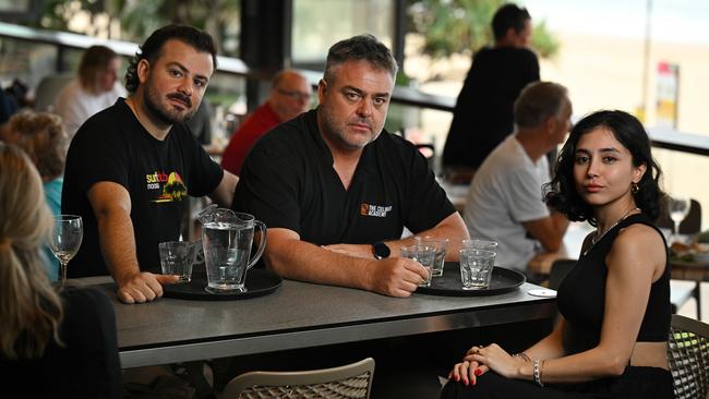 ‘It’s a lottery.’ Lexis Training founder Ian Pratt with international students Bautista Crescimbeni, 25, from Argentina and Nina Irmak, 26, from Turkey, at the Noosa Surf Club on the Sunshine Coast. Picture: Lyndon Mechielsen/The Australian