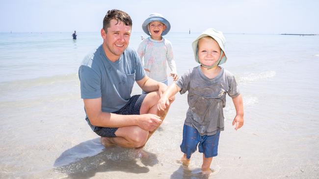 Mawson Hammond, 28, Sutton, 3, and Ashton, 2, from Broken Hill NSW at North Glenelg Beach. Picture: Morgan Sette