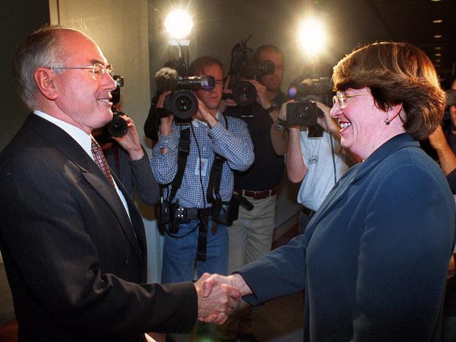 Former prime minister Minister John Howard shakes hands with then Democrats leader Senator Meg Lees after nine days of negotiations secured agreement on the government's GST package in 1999.  Picture:  Michael Jones