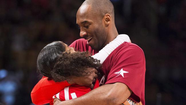 In this Feb. 14, 2016, file photo, Los Angeles Lakers Kobe Bryant (24) hugs his daughter Gianna on the court in warm-ups before first half NBA All-Star Game basketball action in Toronto. Bryant, his 13-year-old daughter, Gianna, and several others are dead after their helicopter went down in Southern California on Sunday, Jan. 26, 2020. (Mark Blinch/The Canadian Press via AP)