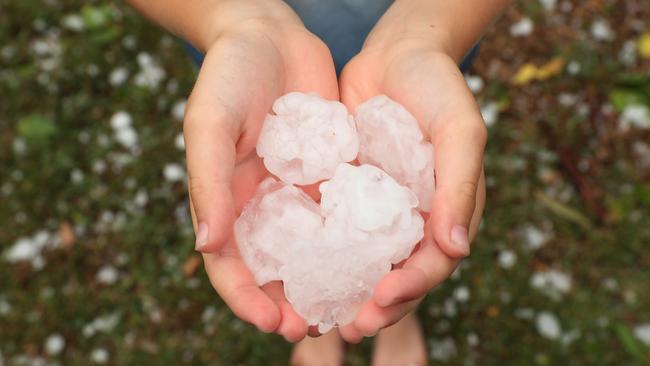 Seven year-old Sebastian Costello with large hail which fell in Gymea, Sydney. Picture: Brett Costello