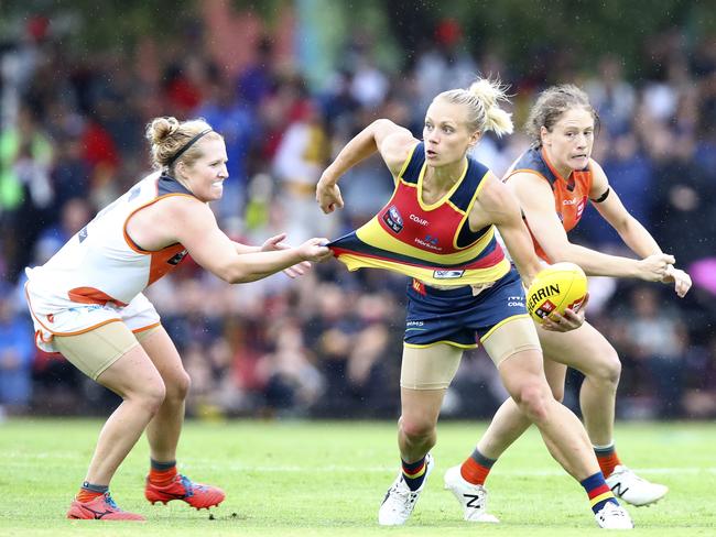 Adelaide Crows’ player Erin Phillips tries to get her handpass away from Britt Tully during the first round of the AFLW league. Picture: Sarah Reed