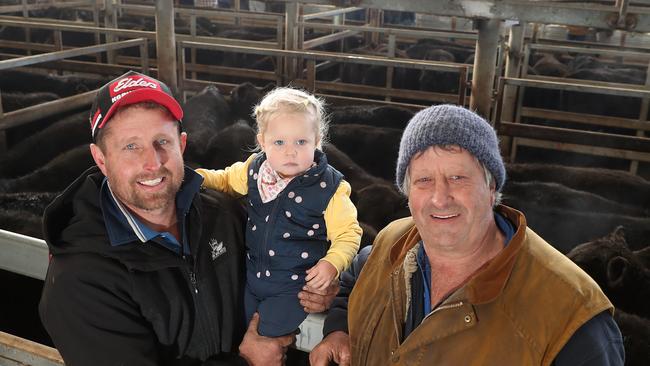 Leongatha Store cattle sale, Jake Follett and his daughter Grace, 2 years old, and Russell Follet from Poowong. Picture Yuri Kouzmin