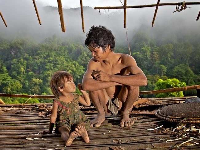 Taut Batu father and daughter in their house, looking down over the Singapan valley, Palawan island, Philippines. Picture: Alegra Ally