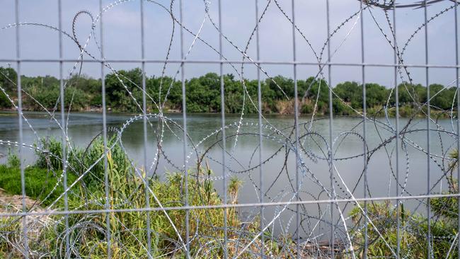 An area covered in razor wire near the Rio Grande in Eagle Pass. Picture: Sergio Flores/The Australian