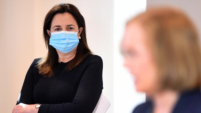 Queensland Premier Annastacia Palaszczuk watches Chief Health Officer Dr Jeannette Young during a Covid update. Picture: NCA NewsWire / Dan Peled