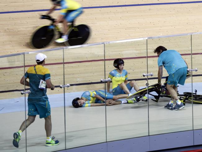 Melissa Hoskins, center left, of the Australian women's track cycling team, reacts after crashing during training.