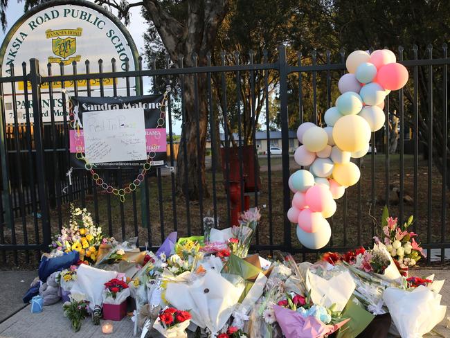 Parents and children left flowers and toys at the school gates today. Picture: John Grainger