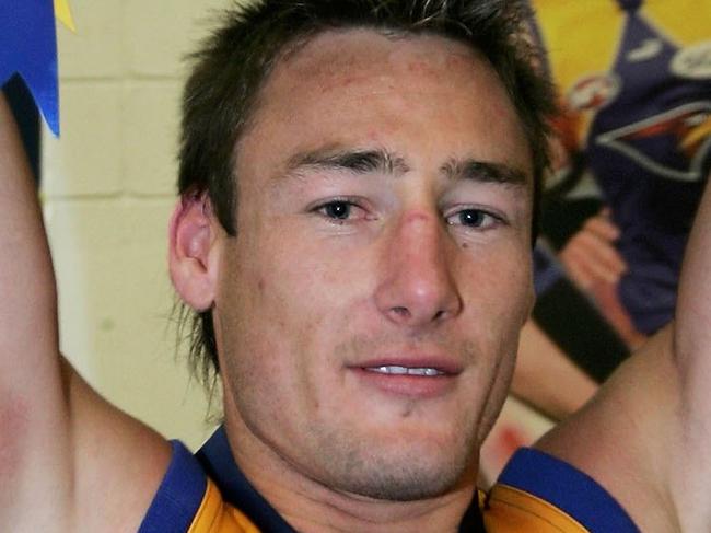 MELBOURNE, AUSTRALIA - SEPTEMBER 30: Adam Hunter of the Eagles lifts the trophy in the rooms after the AFL Grand Final match between the Sydney Swans and the West Coast Eagles at the Melbourne Cricket Ground on September 30, 2006 in Melbourne, Australia. (Photo by Mark Dadswell/Getty Images)